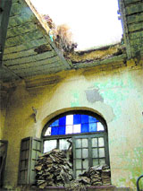 A view of the crumbling roof of a dilapidated 19th-century building inside which employees of the Punjab State Cooperative Society work