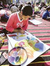 Children participate in a spot-painting competition in New Delhi on Sunday.