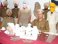Three alleged terrorists, with muffled faces, who were nabbed with a rich haul of RDX, detonators and pencil bombs.  Photo by Inderjeet Verma