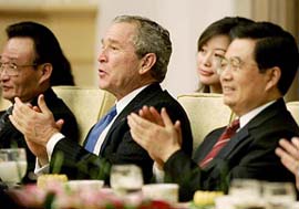US President George W. Bush (centre) applauds a cultural performance with Chinese President Hu Jintao (right) during a dinner at the Great Hall of the People in Beijing on Sunday. Bush is in China on a two-day visit.