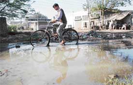 The overflowing nullah floods an approach road to 20 factories in Industrial Area A in Ludhiana on Monday