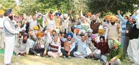 Employees raise their hands to express solidarity with the PAU Employees United Front