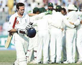 England captain Michael Vaughan walks back to the pavilion after being dismissed by Pakistani bowler Rana Naved-ul-Hasan on the second day of the second Test at the Iqbal Stadium in Faisalabad