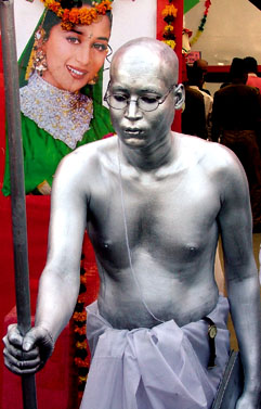 A BSF constable stands like a statue of Mahatma Gandhi at the BSF Mela organised by the BSF Wives Association in the Capital