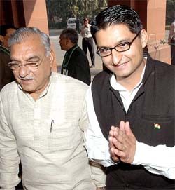 Newly-elected MP from Rohtak Deepender Singh Hooda with his father and Chief Minister of Haryana, Mr Bhupinder Singh Hooda, as they enter Parliament House on the first day of the Winter Session in New Delhi