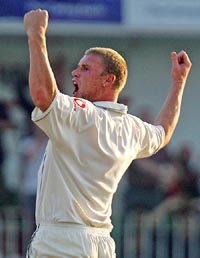 Englands Andrew Flintoff celebrates after bowling Pakistans Shahid Afridi on the fourth day of the second Test in Faisalabad