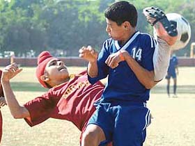 Navjot of Shivalik Public School attempts a reverse kick in a match against Chandigarh Football Academy during the Mini Under-14 Boys Football Tournament at Sector 17, Chandigarh