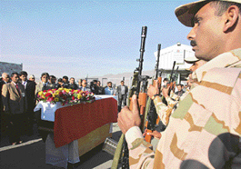 Security personnel from the Indian Embassy in Kabul give an official salute to the casket of Indian Border Roads Organisation (BRO) driver M. R. Kutty at the Kabul International airport on Thursday.