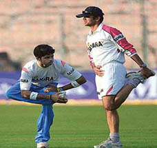 Indian captain Rahul Dravid and team-mate S. Sreesanth perform stretching exercises during a training session