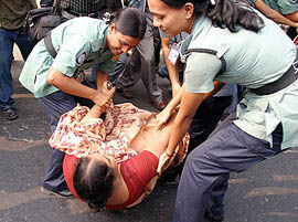 Bangladesh police drags away an Opposition activist during a general strike in Dhaka