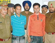 Sunil Singh, alias Chikna, and Harish Sharma, alias Billa, the murder accused, in the police custody in Sector 36 in Chandigarh on Friday. 