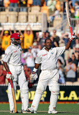 Brian Lara of the West Indies raises his bat on completing his double century during the first day of the third Test against Australia