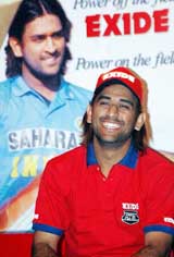 Cricketer Mahendra Singh Dhoni smiles at a press conference in Kolkata on Saturday. Dhoni has been signed as brand ambassador for Exide batteries.