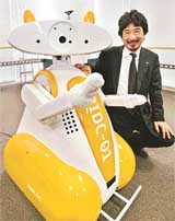 Japanese robot maker Tmsuk President Yoichi Takamoto unveils a guide and floor cleaning robot, RIDC-01, which can recognise human voice and speak to guests during a press preview in Tokyo on Saturday. The robot, 1.3-m tall and weighing 100 kg, is priced at 10 million yen 