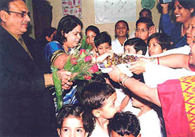 CBI Director US Misra with wife Gayatri distributing sweets after inaugurating a health camp at CBI Colony in the Capital on Saturday