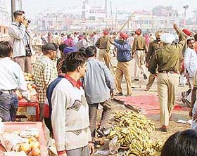 Policemen remove encroachments near the newly constructed bus terminal in Amritsar