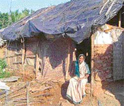 Budhias mother Sukanti sits in front of their house