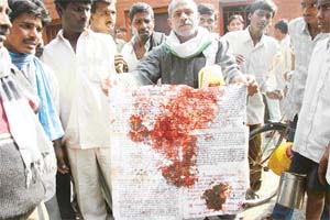 Jail personnel shows blood-stained warning posters issued by Maoists