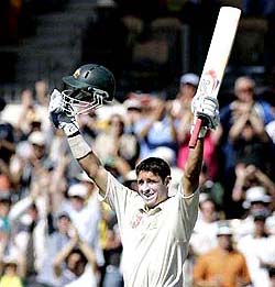 Australias Michael Hussey celebrates after scoring a century during the third day of the third Test against the West Indies in Adelaide on Sunday