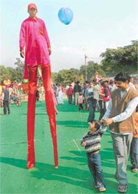 WHEN WILL I BE SO TALL? This is what the little boy is wondering as he watches a stilt-walker at the Carnival in Chandigarh on Sunday afternoon