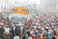 The golden palki passes through Ludhiana streets while on its way from New Delhi to Nankana Sahib in Pakistan, on Monday
