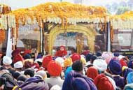 The golden palki passes through Ludhiana streets while on its way from New Delhi to Nankana Sahib in Pakistan, on Monday