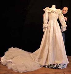 A replica of the dress worn by Princess Diana on her wedding on July 29, 1981, is displayed by an employee of the Cooper Owen auction house on Tuesday at the Proud Gallery, in Camden