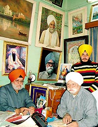 Satpal Danish, Surinder Singh and Hardip Singh with the portraits of Bhai Gian Singh Naqqash and G.S. Sohan Singh