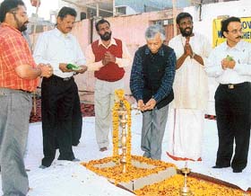 Mr T.K.A. Nair, Principal Secretary to Prime Minister Manmohan Singh, lights a lamp to mark the beginning of the Makkar Sankranti puja at Sree Ayyappa Mandir in Ludhiana