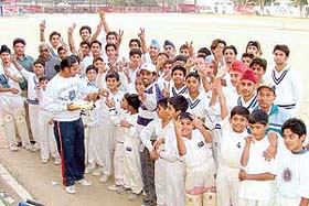 Sweets being distributed among young cricketers on the election of M.P. Pandove to the Board of Control for Cricket in India (BCCI), in Ludhiana