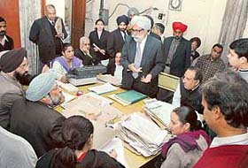 District Consumer Disputes Redressal Forum President A.S. Narula hears litigants during a Lok Adalat in Ludhiana