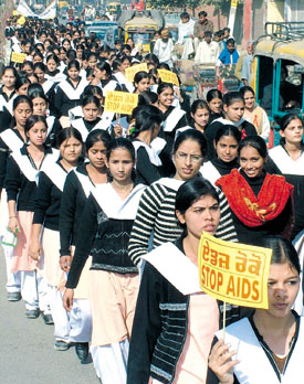 School students carry placards during an AIDS awareness rally to mark the World AIDS Day in Jalandhar on Thursday