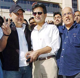 Film Actor Anupam Kher and producer Mahesh Bhatt pose with director of Kara Film Festival Hassan Zaidi for photographers upon arrival at Jinnah International Airport in Karachi on Thursday