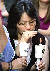 A woman gets emotional as she participates in a candlelight vigil in Sydney on Thursday on the eve of the scheduled execution of Australian Tuong Van Nguyen in Singapore