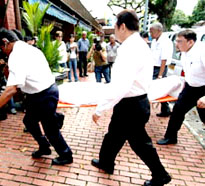Funeral service personnel carry the body of hanged Australian heroin smuggler Nguyen Tuong Van for embalming in Singapore on Friday