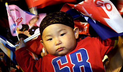 A child waves a flag at an election-eve rally in Panchiao, Taipei December 2, 2005