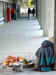 A woman fruit-seller waits for customers in the cold in Chandigarh