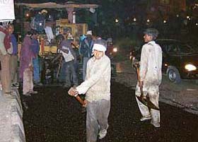 Labourers working at night to recarpet the Pakhowal road in Ludhiana