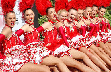 The Moulin Rouge cabaret dancers from Paris pose before photographers in New Delhi on Saturday. The popular group will perform in Delhi on Sunday