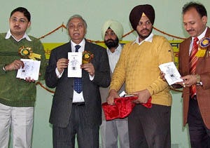 Finance Minister Surinder Singla releases a copy of the Persons with Disabilities Act, 1995, during a function to mark World Disabled Day in Bathinda on Saturday.