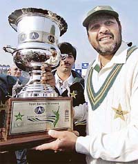 Skipper Inzamam-ul-Haq holds the trophy after Pakistan won the third Test against England to clinch the series 2-0 at the Gaddafi Stadium in Lahore