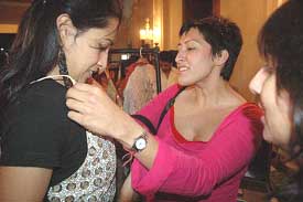 A foreign fashion designer shows her designs to a customer at the Lifestyle exhibition in Kolkata on Sunday.