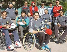 Winners of the wheelchair total tennis tournament with officials after the prize distribution function at Sector 11 in Chandigarh