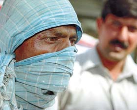Shiekh Ganore, alias Nagendra, who used to give poisoned biscuits to the passengers, arrested by the Railway Police, at New Delhi Railway Station, in the Capital