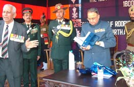 Punjab Governor, General S.F. Rodrigues (Retd), leafs through the book on the history of the 5th Maratha Light Infantry which he released in Kapurthala on Sunday. Also seen in the picture is the author of the book, Maj-Gen E. DSouza (Retd) (extreme left).