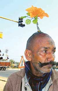 This BJP faithful has a lotus on his forehead and one that holds up his braid