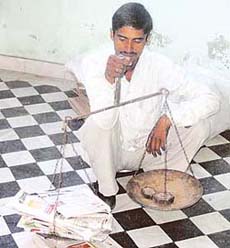 Vijay Kumar at his job of collecting waste paper from a house in Ahmedgarh