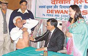 Mr Surinder Dawar, Parliamentary Secretary, looks on as Dr Narottam Diwan examines a patient at the month-long free surgical camp on the opening day in Ludhiana