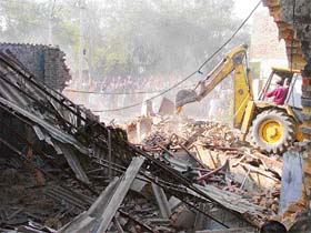A bulldozer in action while removing illegal structures in Ludhiana