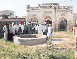Members of the Shah Mohammad Memorial Charitable Trust point out the well that provided the poets link to the Wadala Veeram village.